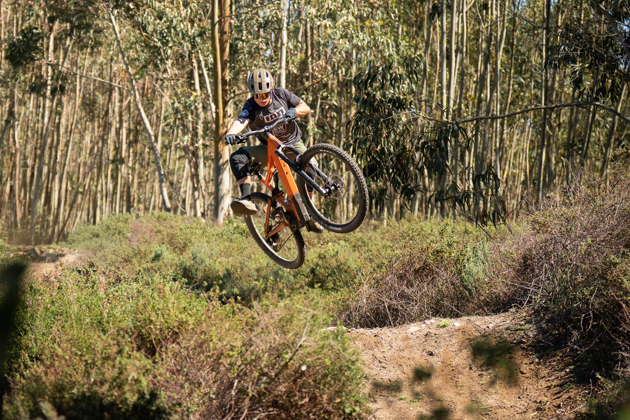Mountain biker climbing toward a high viewpoint